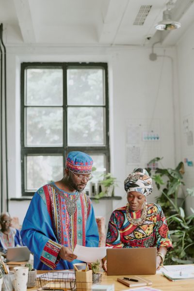 Vertical shot of African American colleagues discussing final report in office